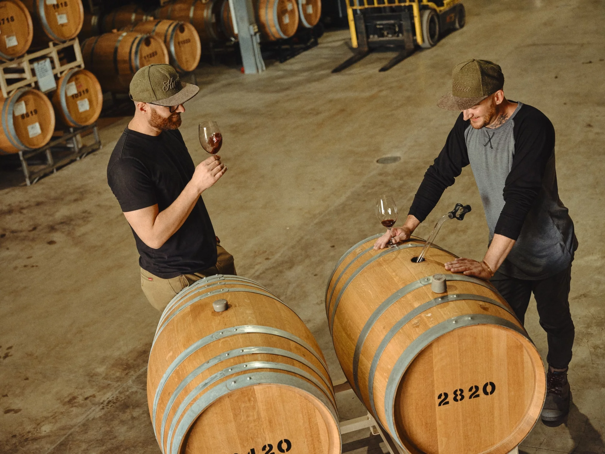 Tasting Room Gallery Two men tasting wine from barrels
