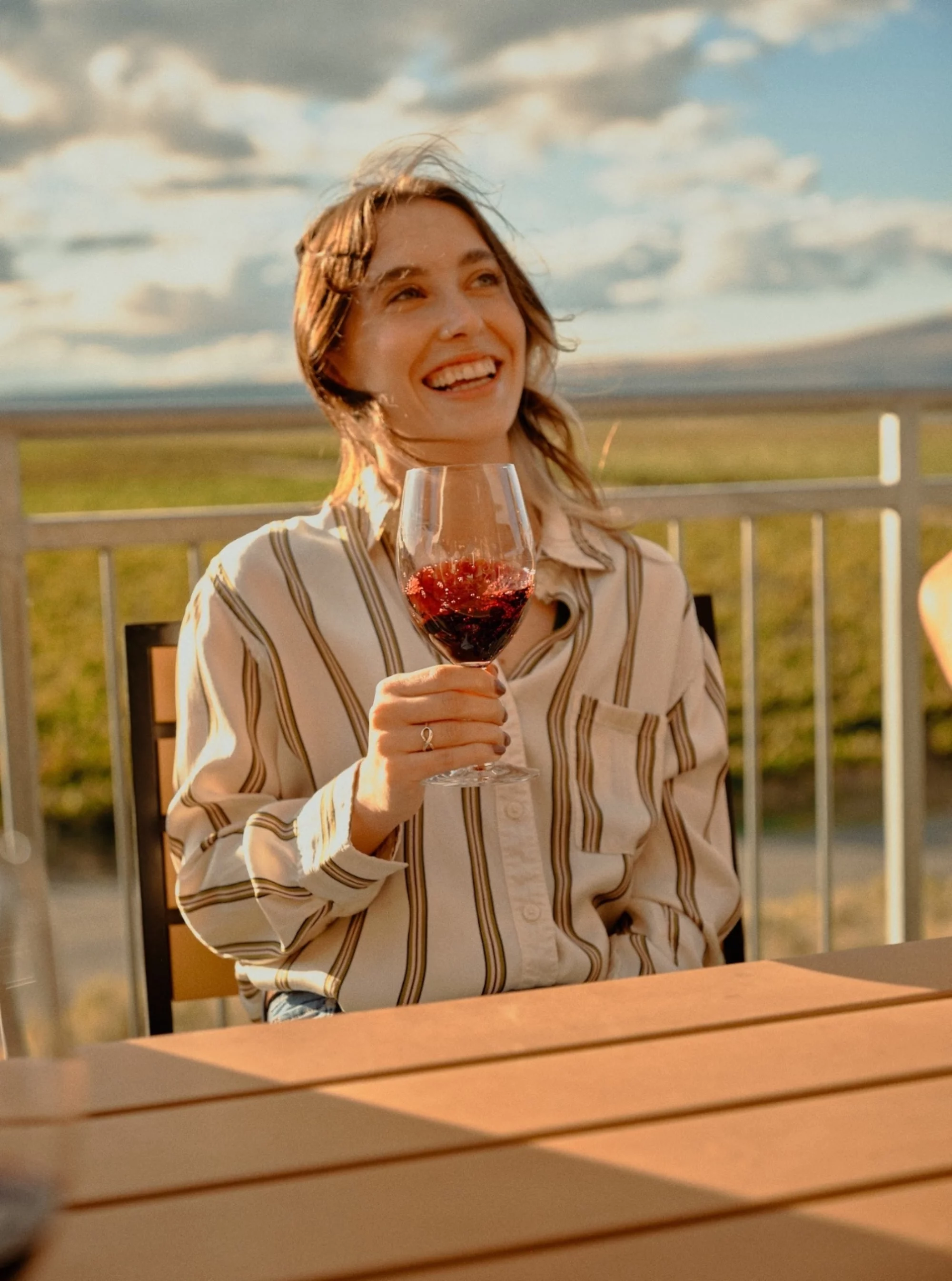 Tasting Room Gallery Woman holding wine glass with sky